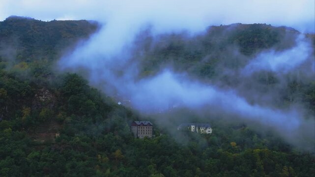 Misty forested hills in Asturias Spain aerial landscape