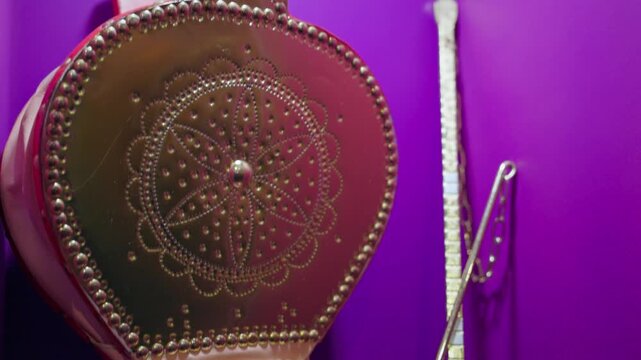 traditional Saudi Arabian dallah (Arabic coffee pot) featuring
intricate embossed geometric and floral patterns, paired with a brass serving
ladle and metal utensils.