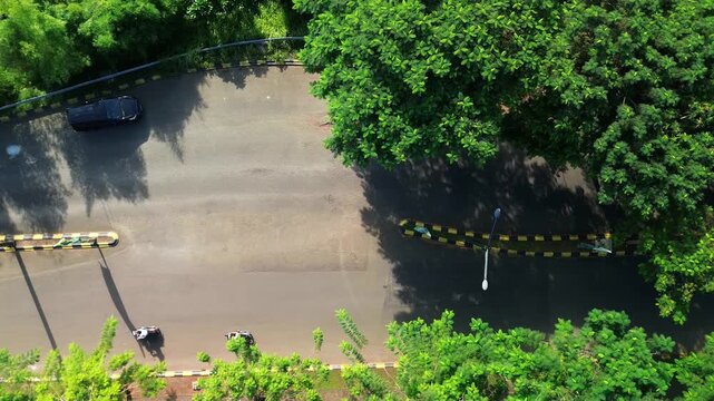 Aerial tracking over parking area with yellow safety barriers
