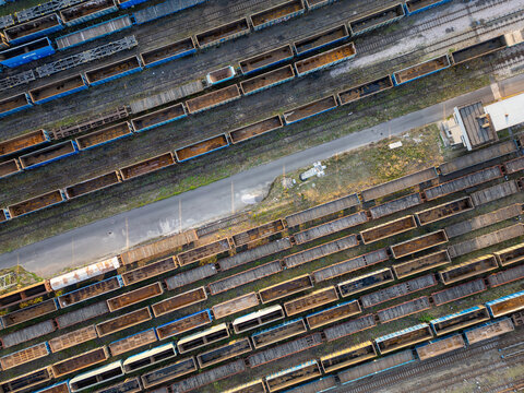 Aerial view of numerous freight train wagons parked on parallel tracks at a large railway cargo terminal Warsaw, Masovian Voivodeship, Poland.