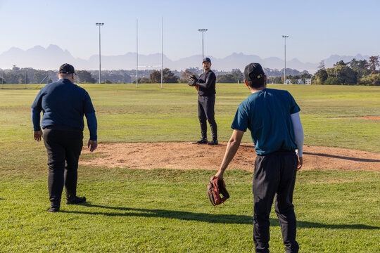 Pitcher prepping glove while fielder walking in, showing animated sports arc over mound and stats