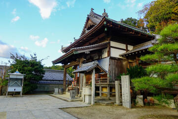 Fototapeta premium Traditional wooden temple hall with ornate roof on Shikoku Henro pilgrimage route in Japan