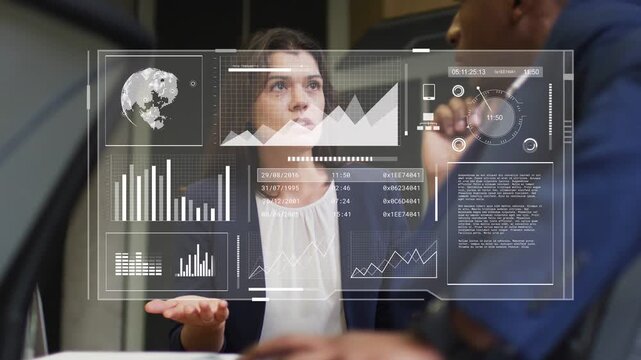 Woman leading business talk, gesturing, man tapping control, dashboard showing map bars for insight