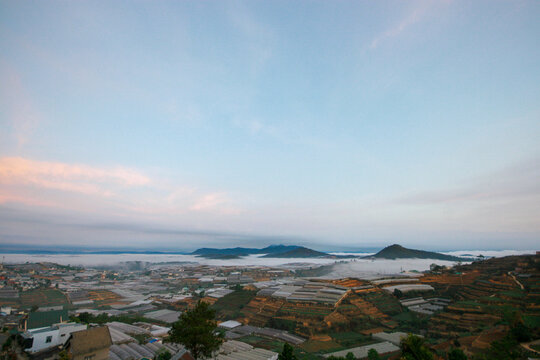 One beautiful morning, before sunrise, in Thai Phien village, a traditional flower village in Da Lat - Lam Dong, a corner of Thai Phien with greenhouses shrouded in early morning mist, a morning in th