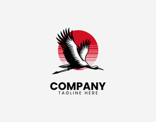 Fototapeta premium Flying crane bird with red sun black vector illustration