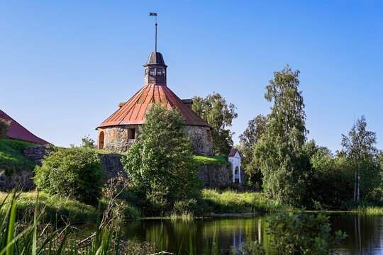 Ancient round tower of the Korela Fortress on the lake shore, Leningrad region of Russia