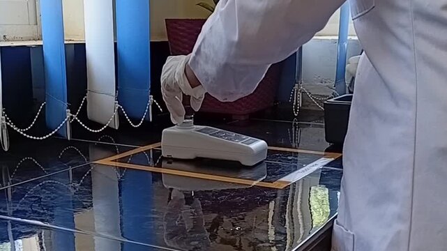 Lab Technician in White Gloves Testing High Turbidity of Raw Water Before Starting Jar Test Procedure