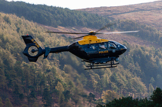 PSNI Helicopter flying through a valley in the Mourne Mountains