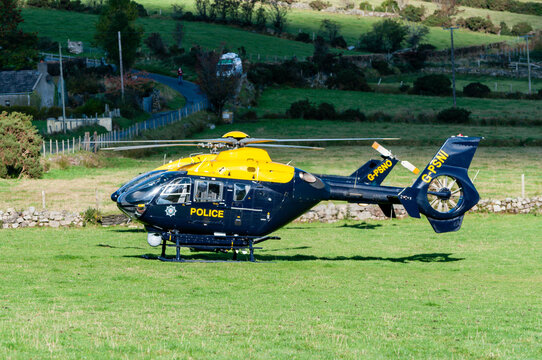 PSNI police helicopter G-PSNI (Eurocopter EC135) (foregroung) and G-PSNO (Eurocopter EC145) (behind) landed in a field during a search and rescue mission