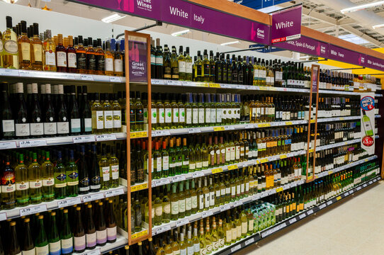 White wine on shelves in the off-licence department of a Tesco store