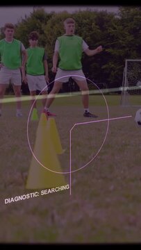 Vertical video: Soccer teen approaching cones, dribbling ball to goal for drill HUD tracking cones