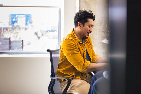 Young asian professional man working at a desk in the office