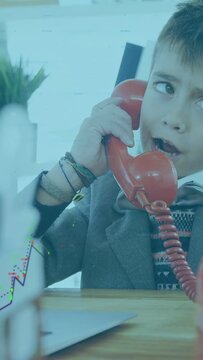 Vertical video: Child lifting red handset and miming call revealing finance chart overlay over desk