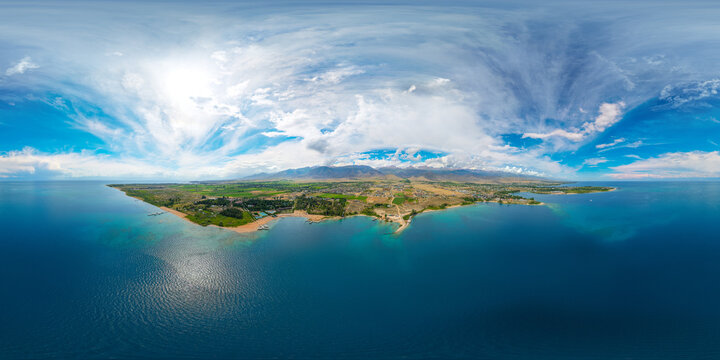 Aerial 360 panoramic view of coastal town by large blue Issyk-Kul lake