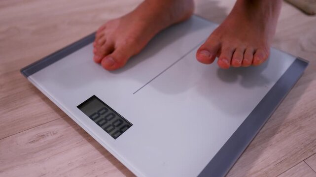Bare Feet Stepping onto Digital Bathroom Scale for Weight Measurement