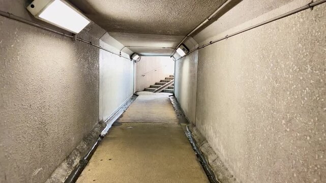Empty Concrete Pedestrian Underpass Tunnel with Fluorescent Lighting in Kanazawa