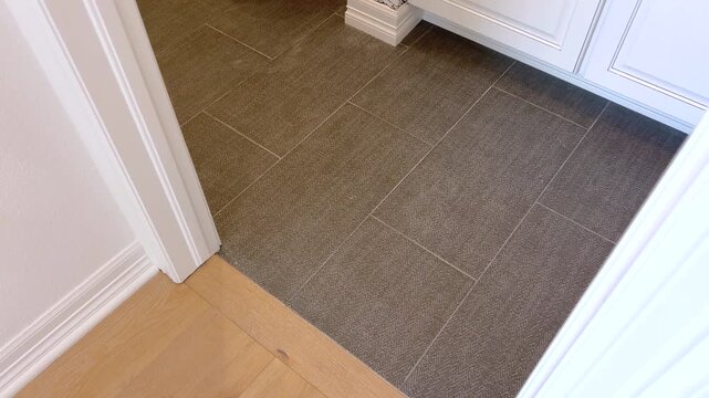 Bathroom with white vanity and dark tile floor