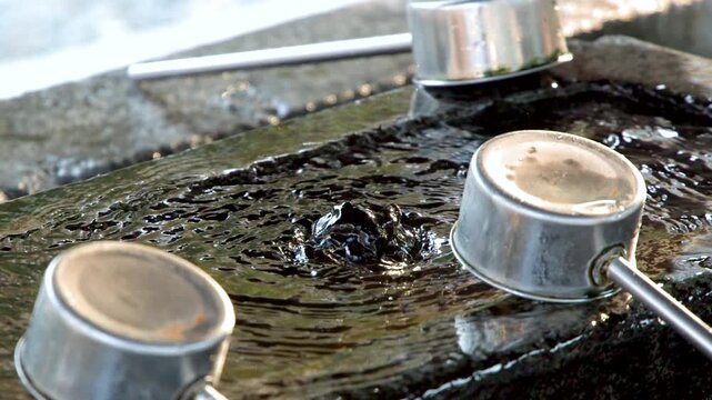 Traditional Japanese Temizuya Water Purification Fountain with Metal Ladles at Oyama Shrine