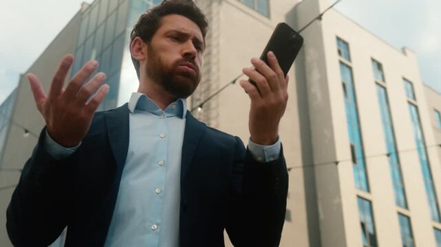 Irritated annoyed Caucasian business man angry trying call broken smartphone sunny city frustrated middle aged businessman male mobile phone connection failure bad signal problem network lost outdoor