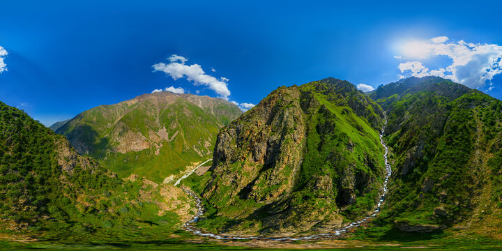 Panoramic equirectangular aerial view of majestic green mountains and river valley in Kyrgyzstan