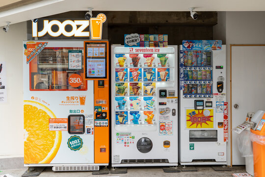 TOSHIMA, TOKYO, JAPAN - APRIL 14, 2026: A row of outdoor vending machines, featuring an IJOOZ fresh orange juice machine, in the Toshima district of Tokyo.