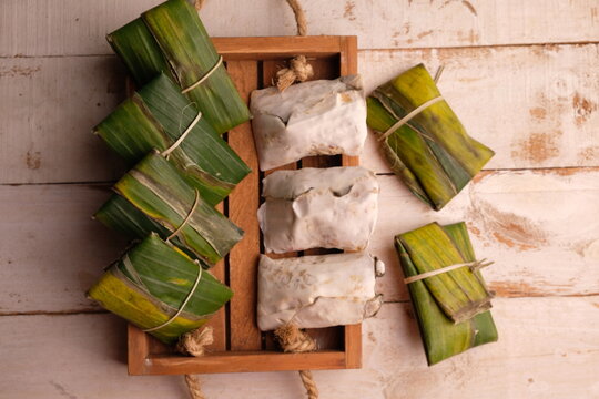 Raw tempeh or tempe. tempeh wrapped in banana leaves. Tempe is a traditional Indonesian food made from fermented soybeans.