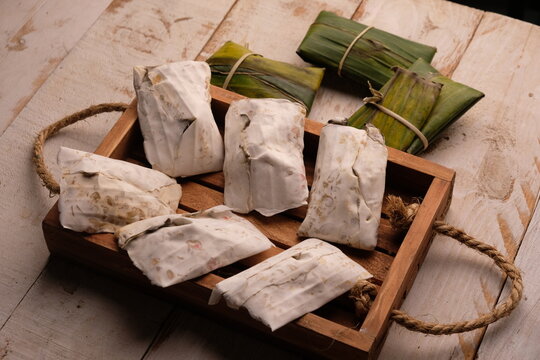 Raw tempeh or tempe. tempeh wrapped in banana leaves. Tempe is a traditional Indonesian food made from fermented soybeans.