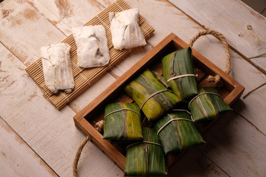 Raw tempeh or tempe. tempeh wrapped in banana leaves. Tempe is a traditional Indonesian food made from fermented soybeans.