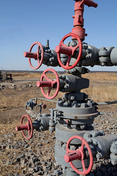Multiple Red Handwheel Valves and Manifold System on Oilfield Wellhead