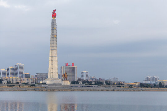 Juche Tower, Pyongyang morning panoramic view, North Korea. Taedong River in the morning fog. View facing upstream, modern residential complex. View from Yanggakdo Hotel
