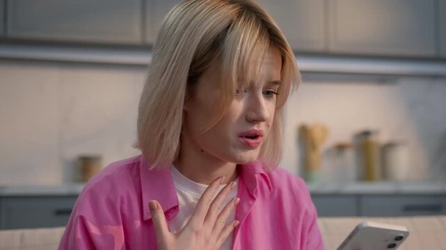 Angry mad Caucasian woman at home furious female talking mobile phone arguing shouting irritated aggressive girl conflict quarrel misunderstanding smartphone call problem annoyed frustrated indoors