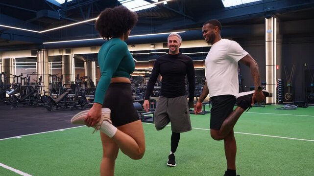 Amputee personal trainer working with clients in a modern gym