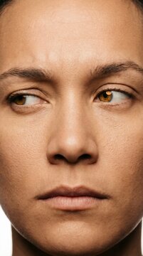 Intense extreme close up of human eyes looking aside with suspicious expression