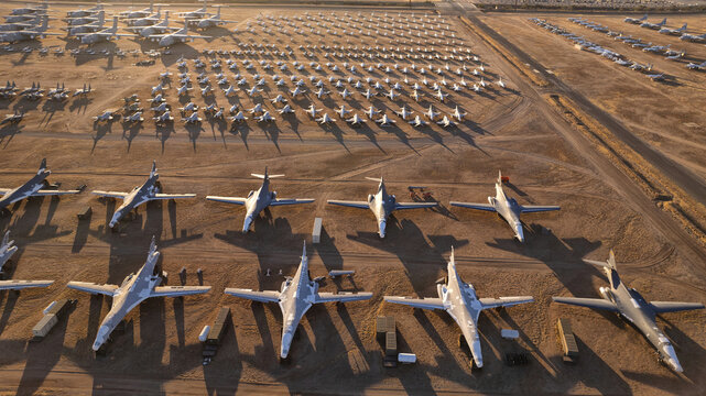 Tucson, United States - 06 February 2025: Aerial view of rows of dormant aircraft glint under the Arizona sun, a silent fleet resting in the vast desert landscape.