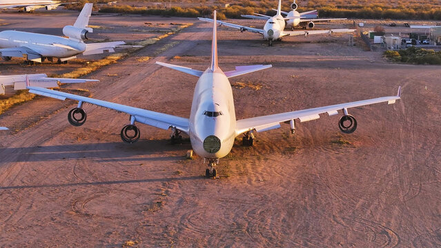 Tucson, United States - 30 November 2025: Aerial view of a colossal Boeing 747 and other retired giants, their pale fuselages stark against the sun-kissed, dusty desert floor.