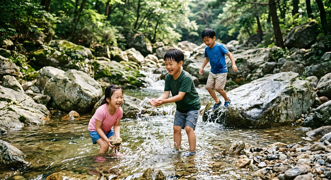 Group of happy Asian children playing with water in a clean mountain stream during summer vacation