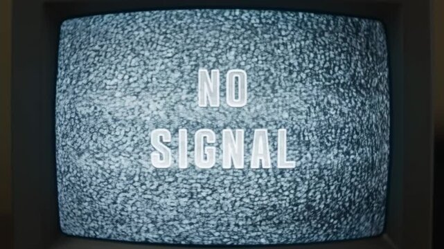 Panning shot of vintage crt televisions displaying no signal static and flicker across dark interior living room shelf in retro analog electronics setup