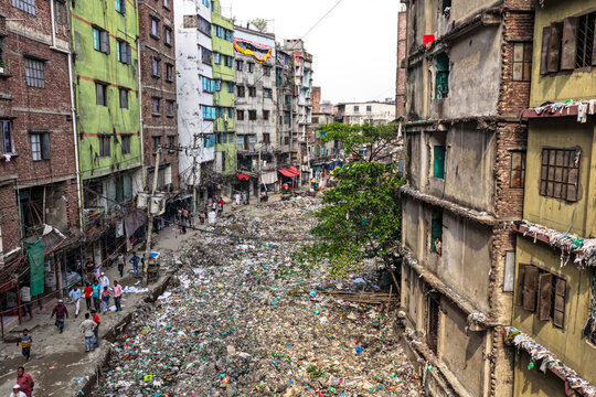 Keraniganj, Bangladesh - 11 April 2026: Aerial view of a river choked with waste, contrasting sharply with the aged buildings lining its banks, a scene of urban decay and environmental concern.