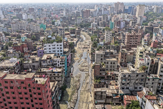 Keraniganj, Bangladesh - 11 April 2026: Aerial view of a densely packed urban landscape, where buildings crowd along a river, showcasing the city's vibrant yet complex tapestry.