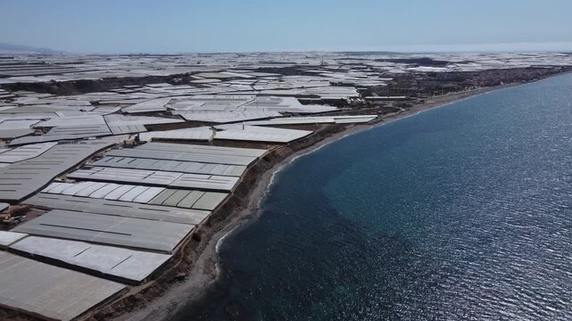 Two seas collide, a plastic one and the Mediterranean. Greenhouses in Almeria, Spain