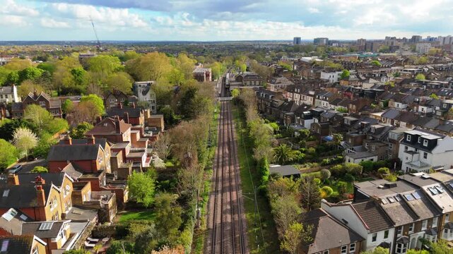 Suburban neighbourhood with railway line cutting through dense residential houses in England