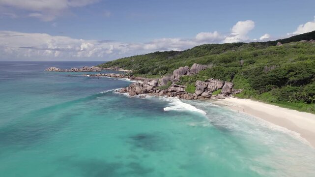 Drone of amazing nature from grand anse beach to anse songe, granite stones, crushing waves, untouched nature, La Digue, Seychelles 30fps 001