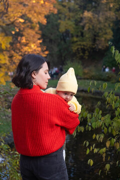 Portrait Mother and Baby Smiling in Autumn Park