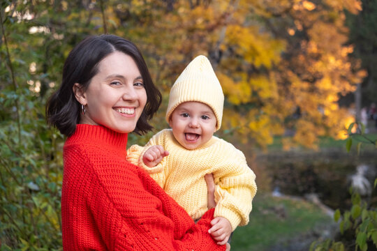 Portrait Mother and Baby Smiling in Autumn Park
