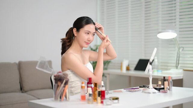 Woman applying skincare and makeup at home, glowing healthy skin, natural beauty routine with cosmetic products