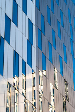 Abstract pattern geometry on modern building facade architecture using reflection in windows as a minimal background for business branding and design