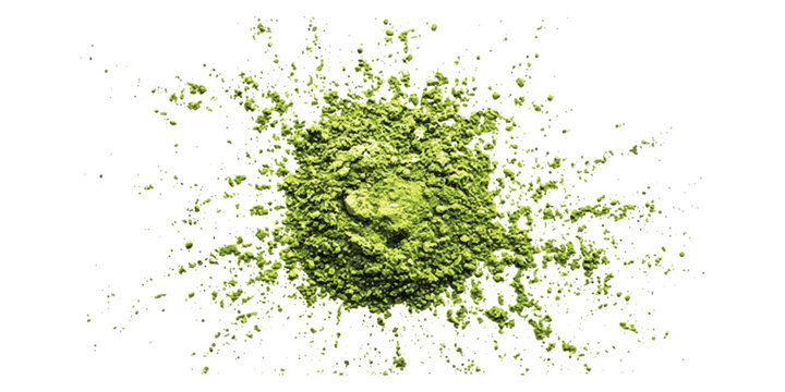 A pile of green matcha tea powder scattered on a surface
