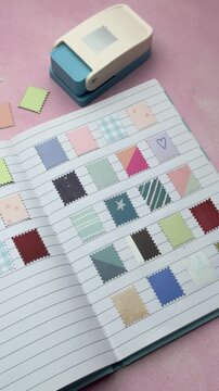 Decorative paper stamps collection organized in a notebook