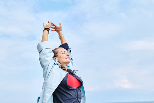 Woman stretching outdoors by the sea enjoying coastal lifestyle