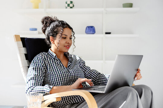 Freelancer working on a laptop indoors at home